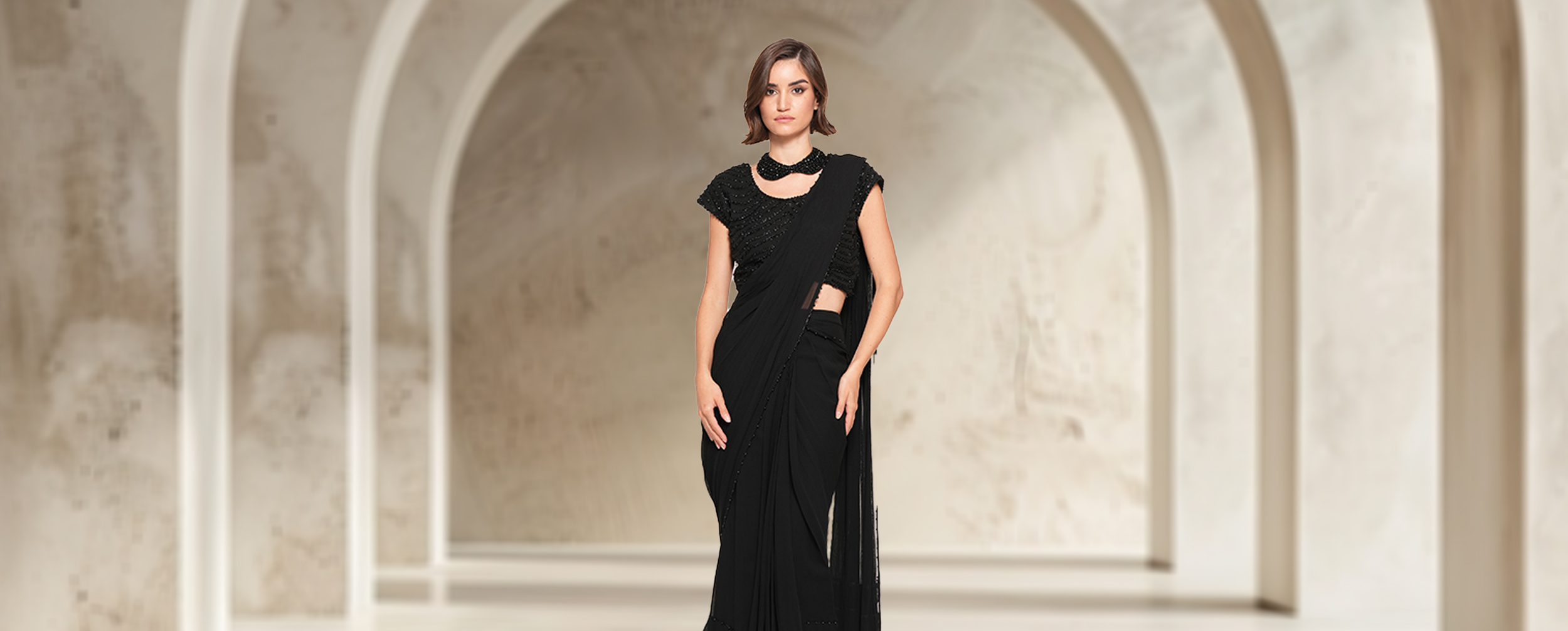 A woman flaunting her black sequin saree